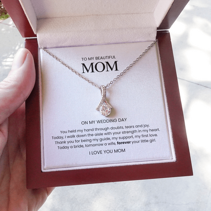 Necklace with a card for 'My Beautiful Mom' on a blurred background
